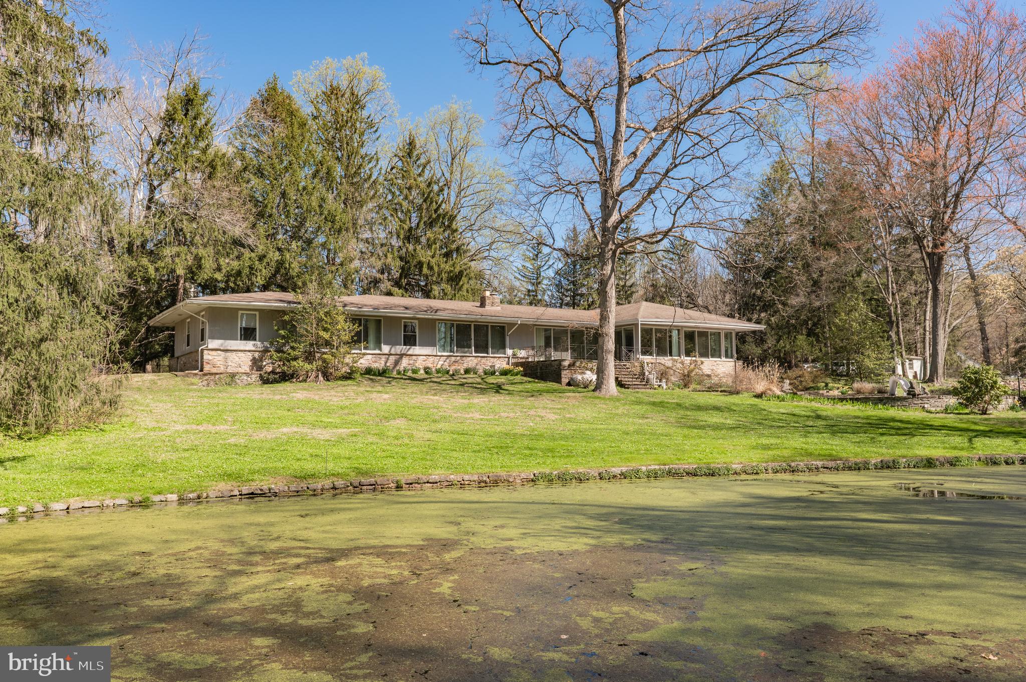 1211 East Butler Pike Ambler, PA 19002 - Photo 3 of 76 a front view of a house with a yard table and chairs