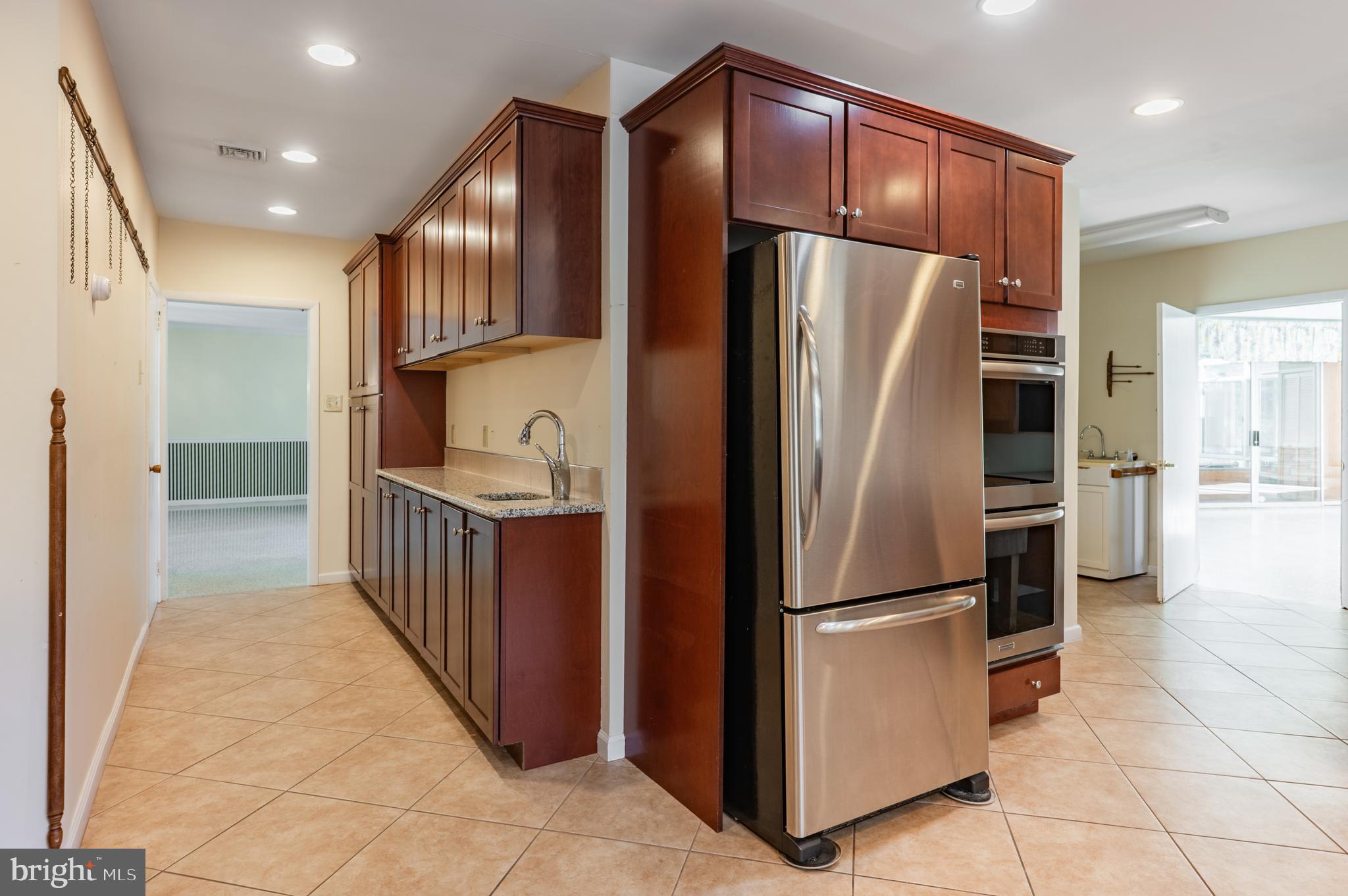 1211 East Butler Pike Ambler, PA 19002 - Photo 32 of 76 a metallic refrigerator freezer sitting inside of a kitchen
