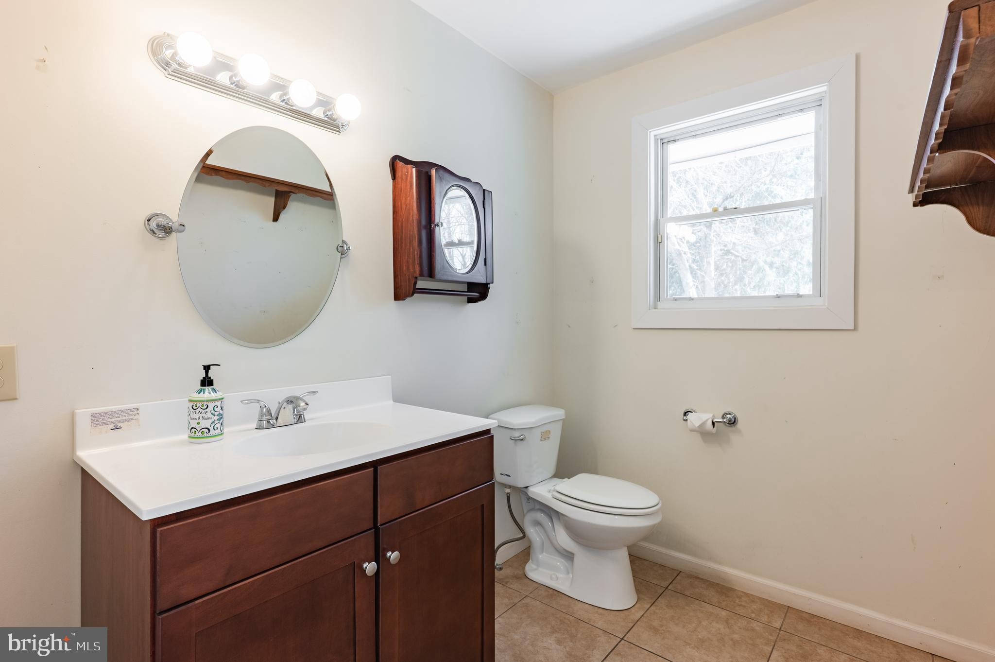 1211 East Butler Pike Ambler, PA 19002 - Photo 35 of 76 a bathroom with a toilet a sink and mirror