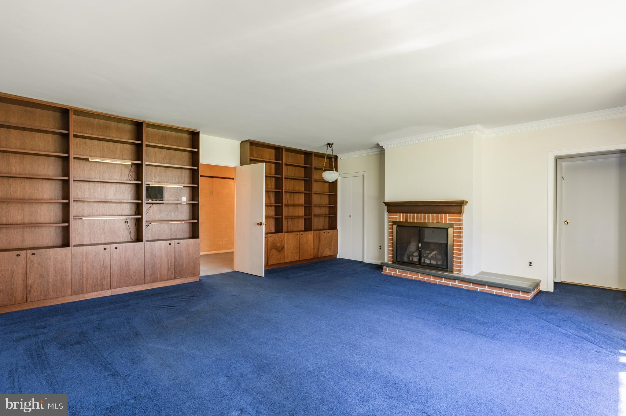1211 East Butler Pike Ambler, PA 19002 - Photo 53 of 76 an empty room with fireplace wooden floor and windows