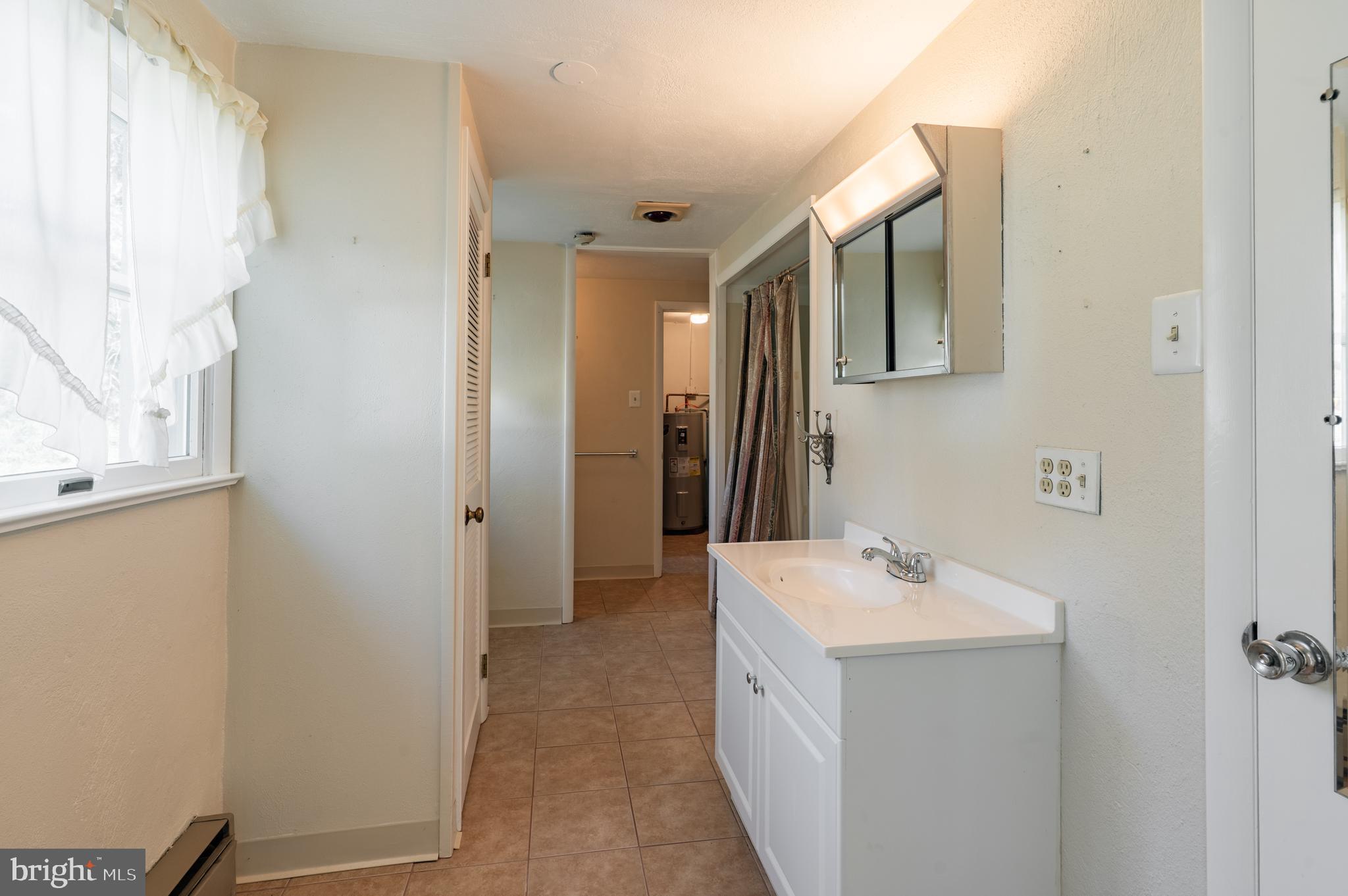 1211 East Butler Pike Ambler, PA 19002 - Photo 67 of 76 a bathroom with a sink mirror and tub