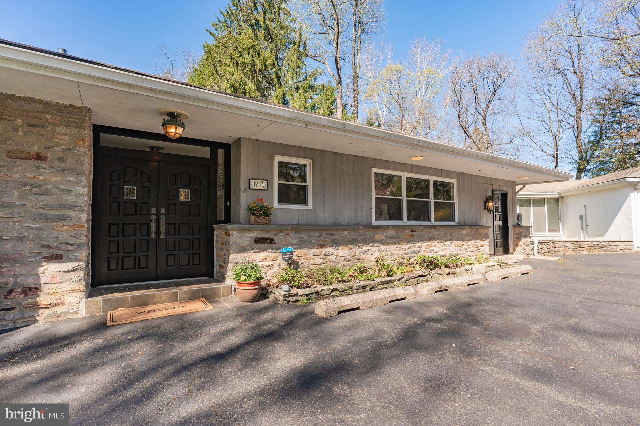 1211 East Butler Pike Ambler, PA 19002 - Photo 10 of 76 a front view of a house with a yard and garage