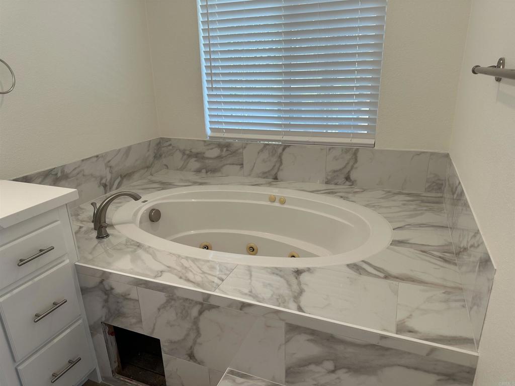 4026 Aidan Circle Carlsbad, CA 92008 - Photo 11 of 26 a bathroom with a sink and a bathtub