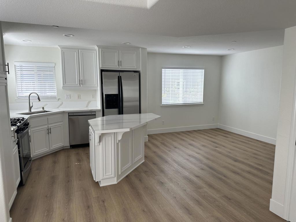 4026 Aidan Circle Carlsbad, CA 92008 - Photo 5 of 26 a kitchen with a sink and cabinets
