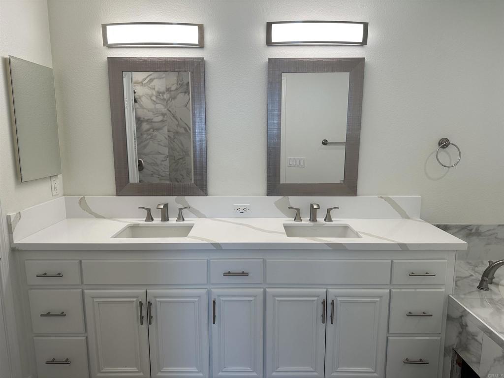 4026 Aidan Circle Carlsbad, CA 92008 - Photo 9 of 26 a bathroom with double sink and a mirror