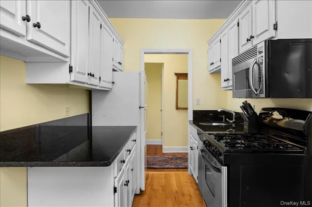 a kitchen with stainless steel appliances granite countertop a stove and a refrigerator
