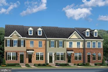 a front view of a residential apartment building with a yard