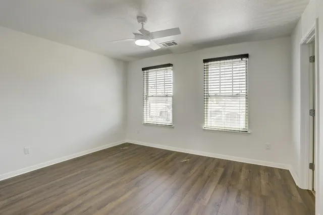 wooden floor in an empty room with a window