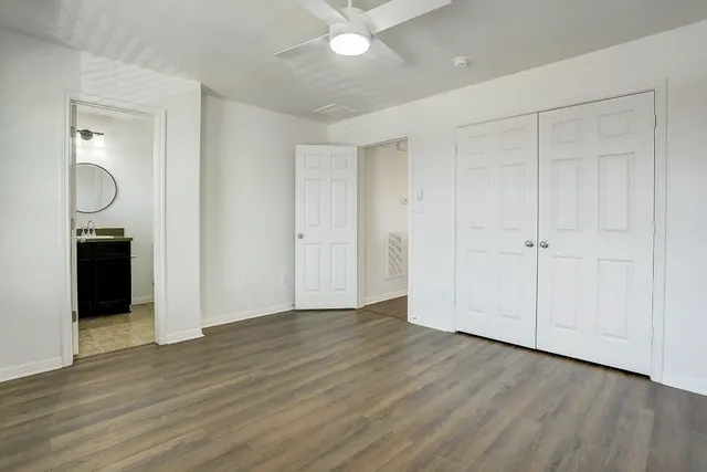 a view of an empty room with wooden floor