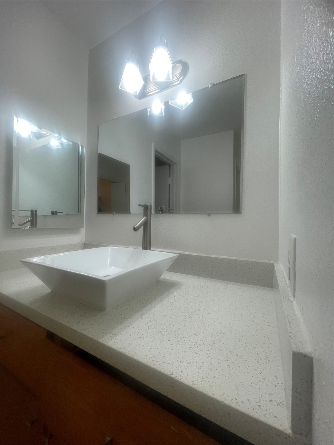701 Rosedale Street, Unit H Houston, TX 77006 - Photo 14 of 20 a bathroom with a sink a large mirror and a light fixture