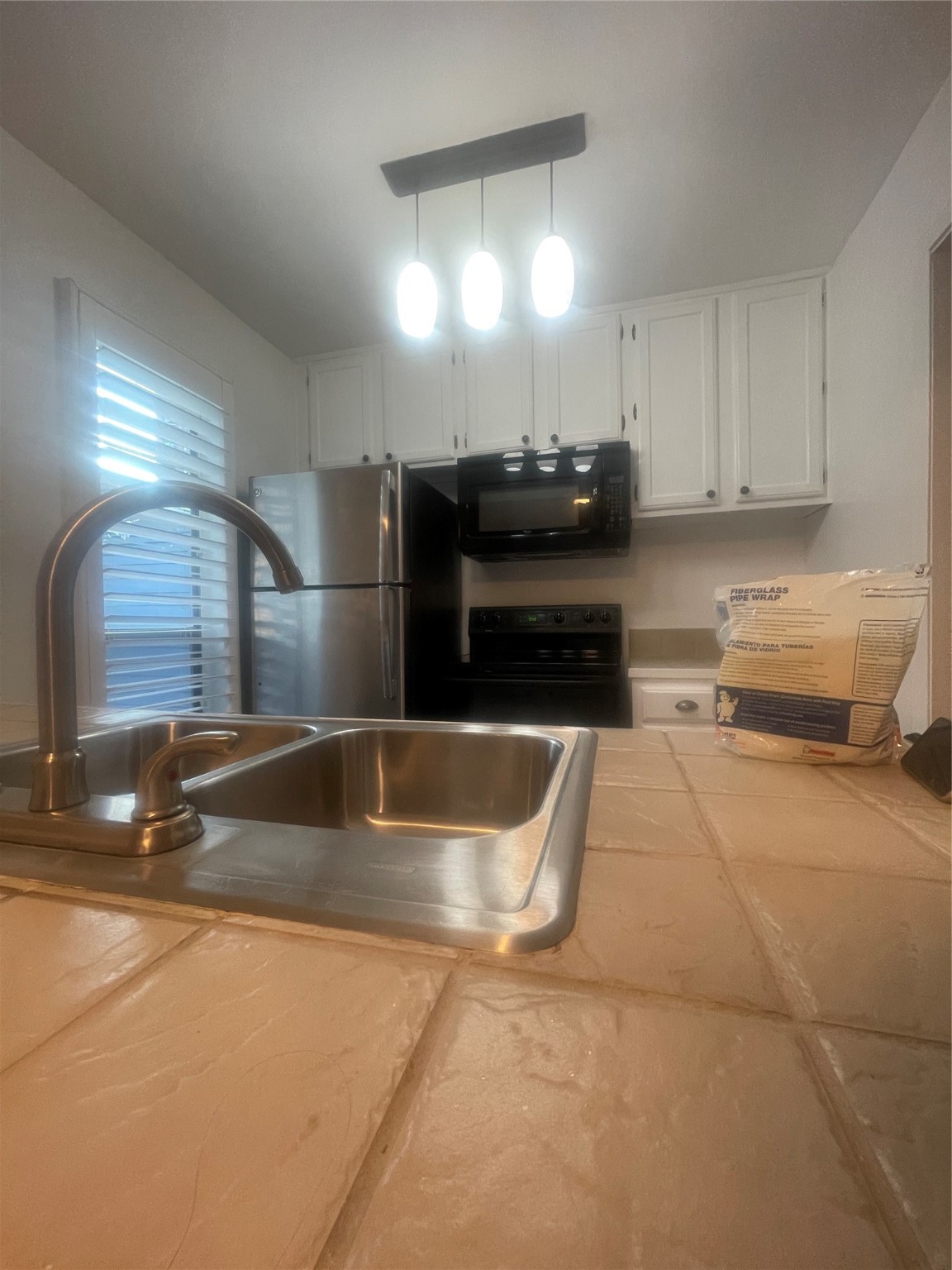 701 Rosedale Street, Unit H Houston, TX 77006 - Photo 3 of 20 a kitchen with stainless steel appliances granite countertop a sink and a stove