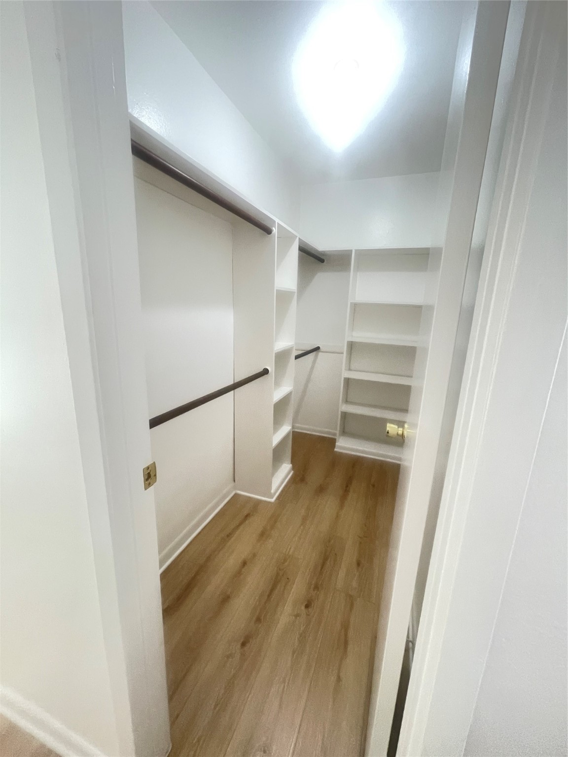 701 Rosedale Street, Unit H Houston, TX 77006 - Photo 9 of 20 a view of walk in closet with empty racks
