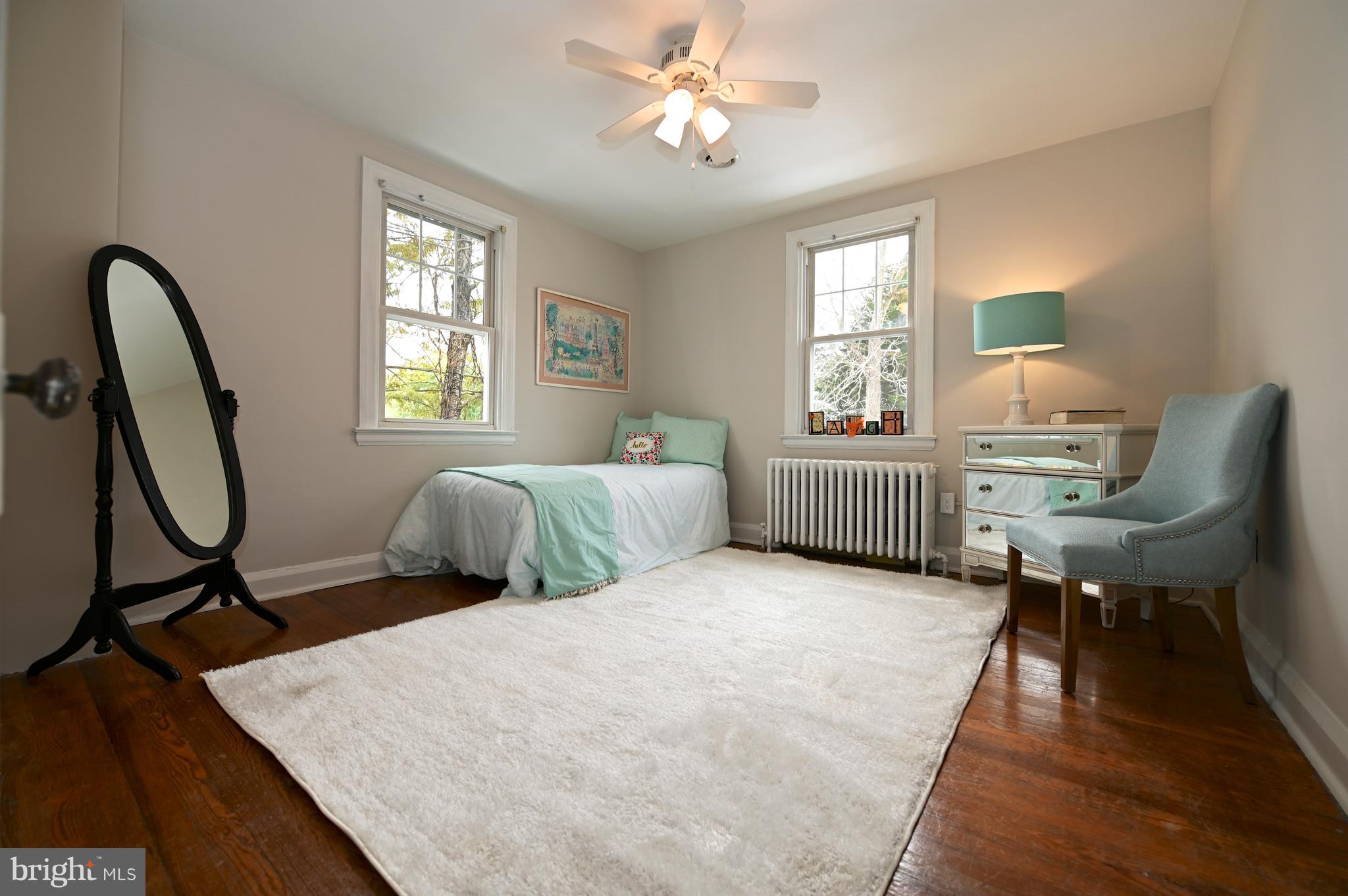 6208 Pimlico Road Baltimore, MD 21209 - Photo 22 of 43 a bedroom with a bed a desk and chair with window