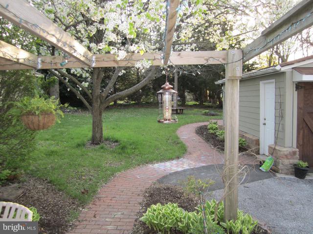 6208 Pimlico Road Baltimore, MD 21209 - Photo 40 of 43 a view of a yard with plants and a table and chairs