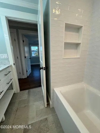 a bathroom with a bathtub and a shower