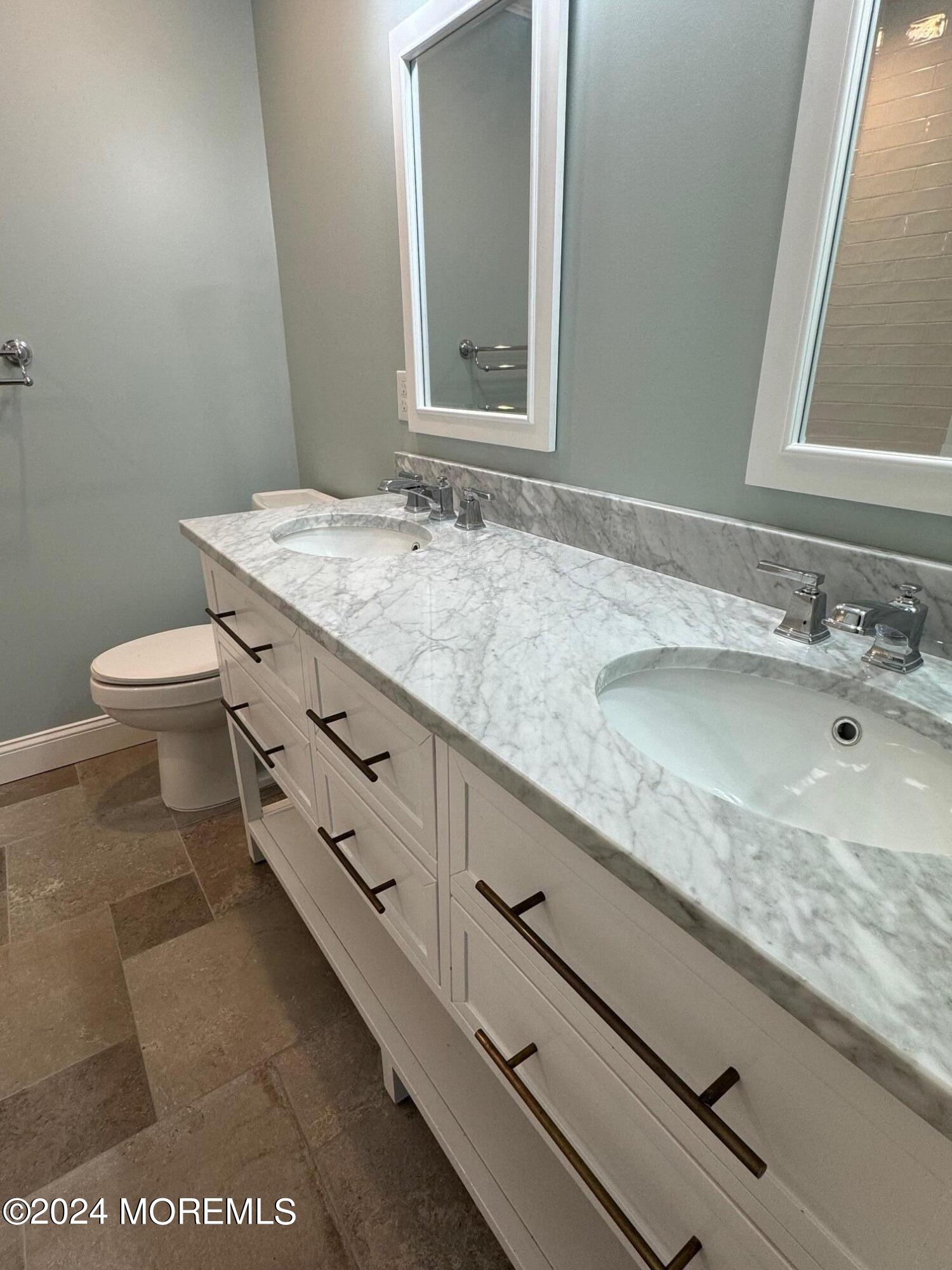 67 Sunset Avenue Red Bank, NJ 07701 - Photo 27 of 39 a bathroom with a granite countertop sink a toilet and mirror