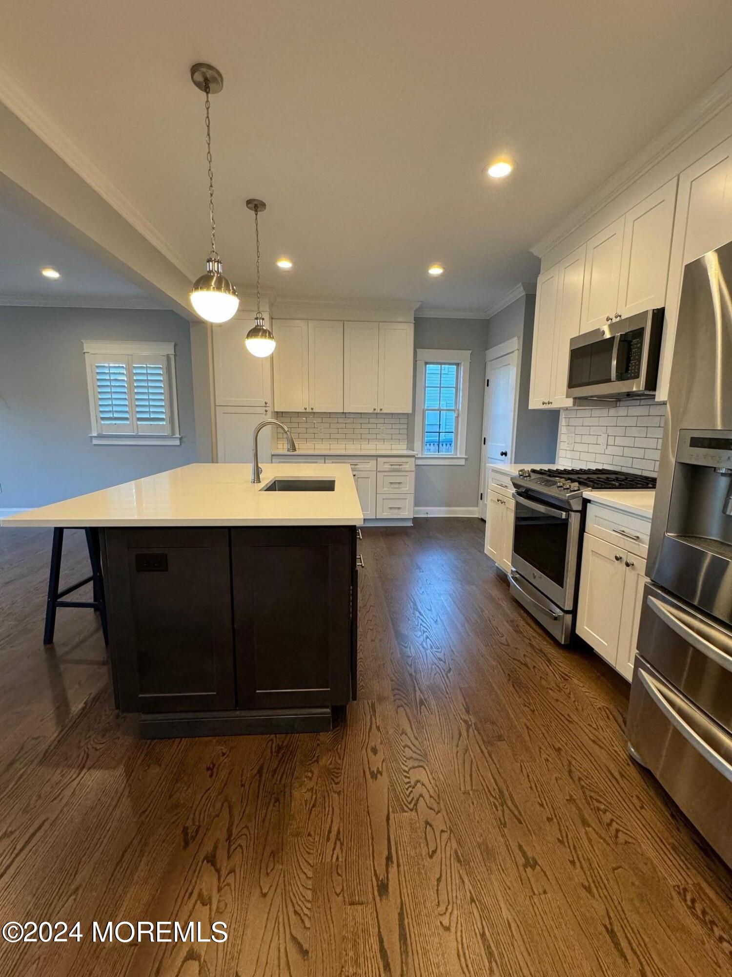 67 Sunset Avenue Red Bank, NJ 07701 - Photo 4 of 39 a kitchen with kitchen island a sink stainless steel appliances and cabinets