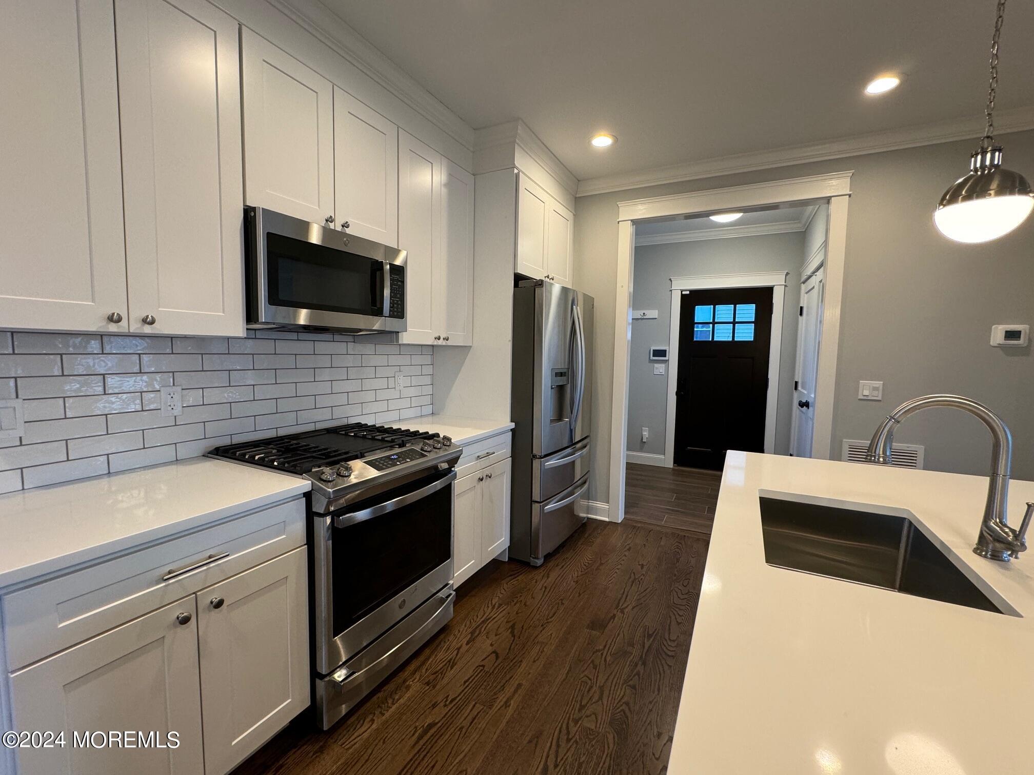 67 Sunset Avenue Red Bank, NJ 07701 - Photo 9 of 39 a kitchen with stainless steel appliances a stove microwave and sink