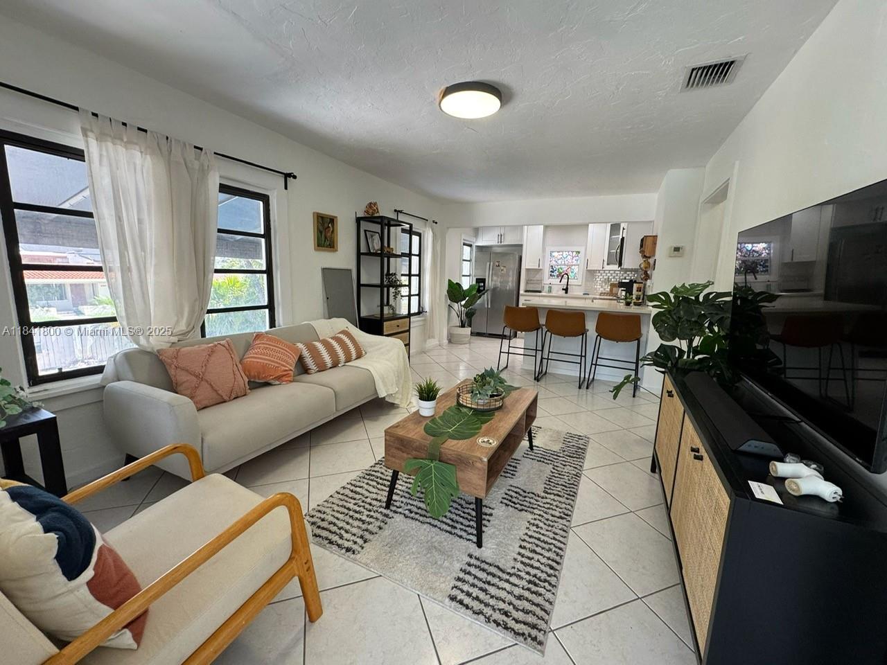 3901 Southwest 6th Street, Unit 1 Miami, FL 33134 - Photo 1 of 6 a living room with furniture and a flat screen tv