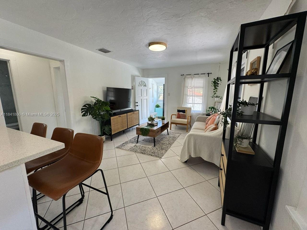 3901 Southwest 6th Street, Unit 1 Miami, FL 33134 - Photo 2 of 6 a living room with furniture and a flat screen tv
