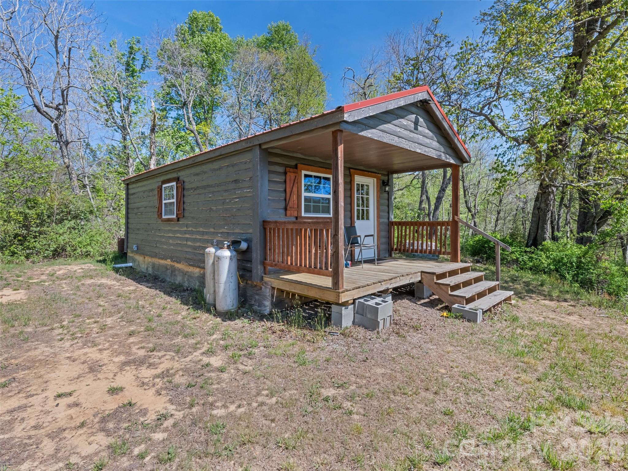 1372 Sand Branch Road Black Mountain, NC 28711 - Photo 32 of 45 a view of a house with a yard and sitting area