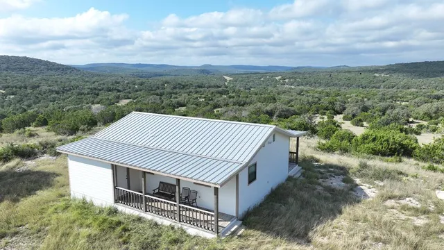 an aerial view of a house with a yard