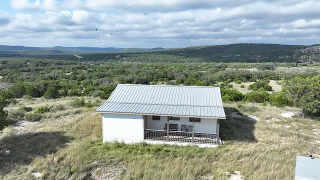 a view of a field with trees in the background