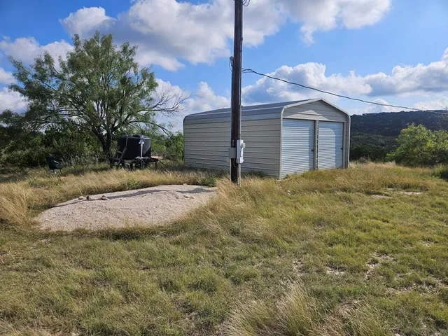 a backyard of a house with table and chairs