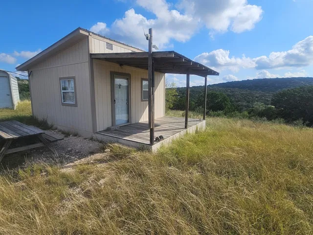 a view of a house with backyard and porch