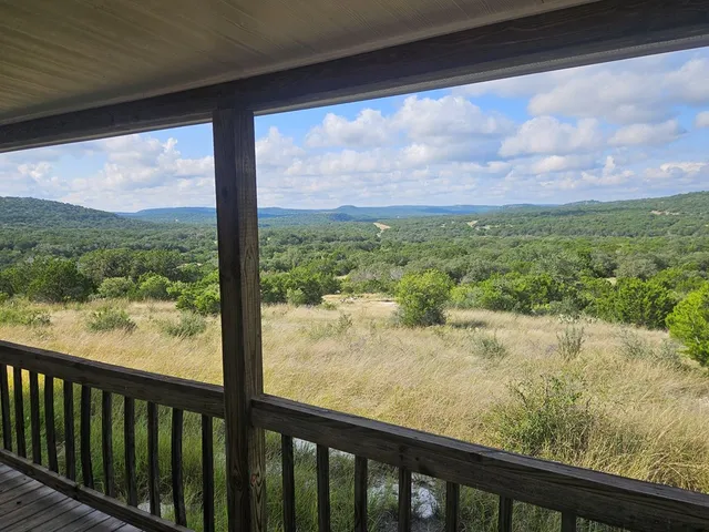 a view of a forest from a balcony