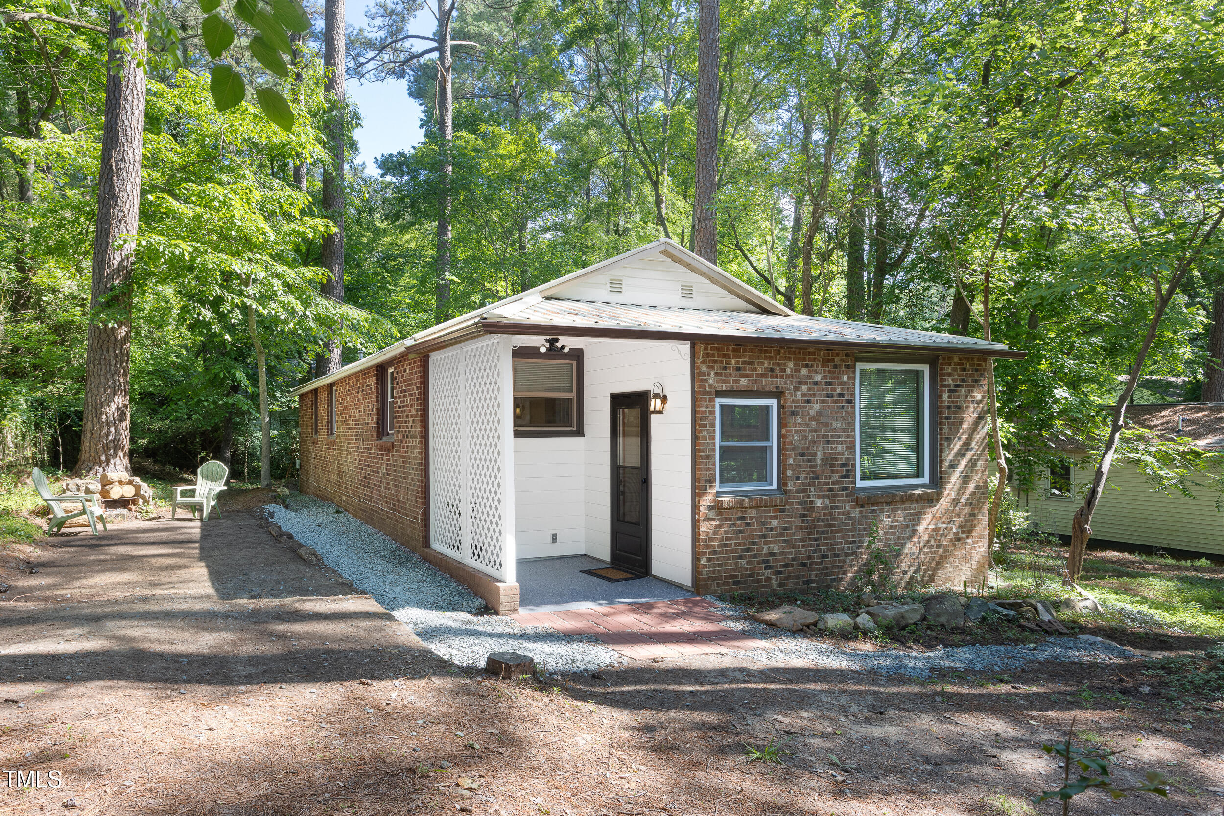 a front view of a house with a yard and trees