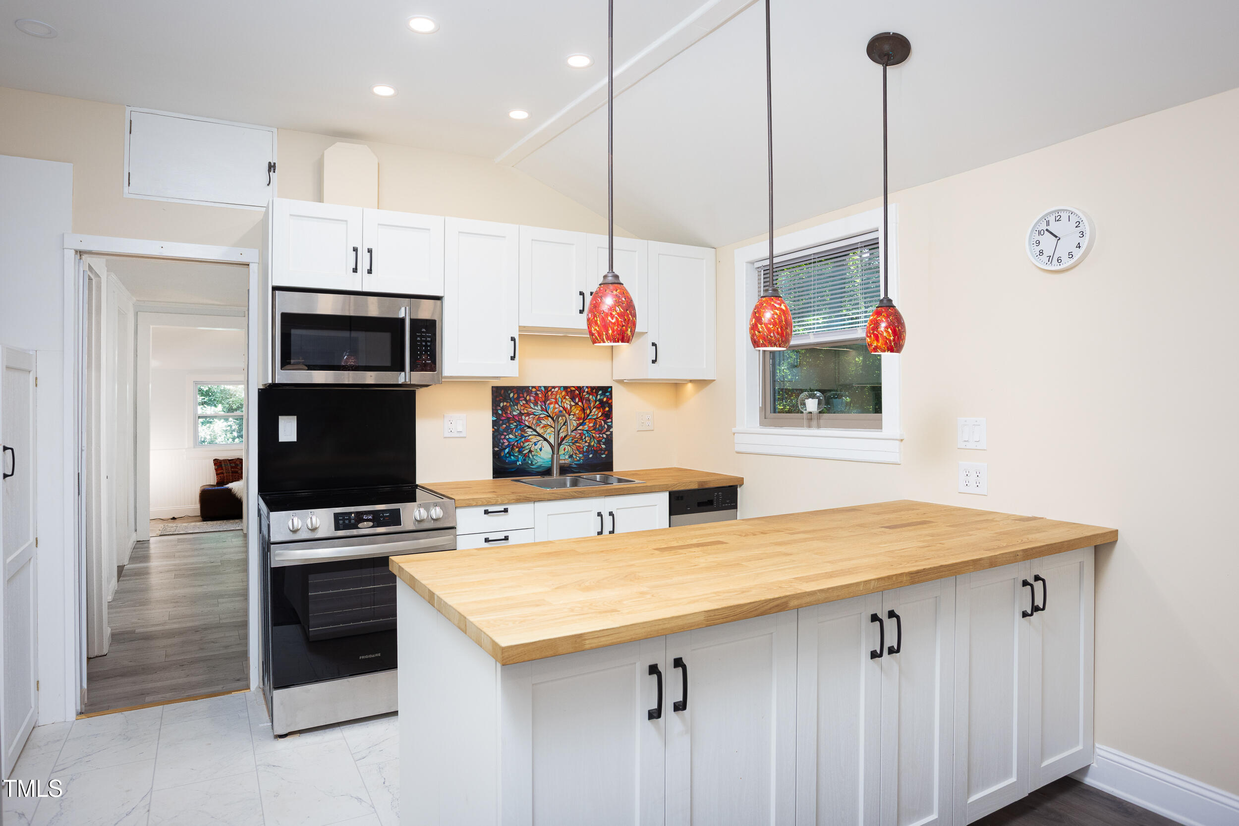126 Barclay Road Chapel Hill, NC 27516 - Photo 12 of 39 a kitchen with stainless steel appliances kitchen island granite countertop a sink a stove and a refrigerator