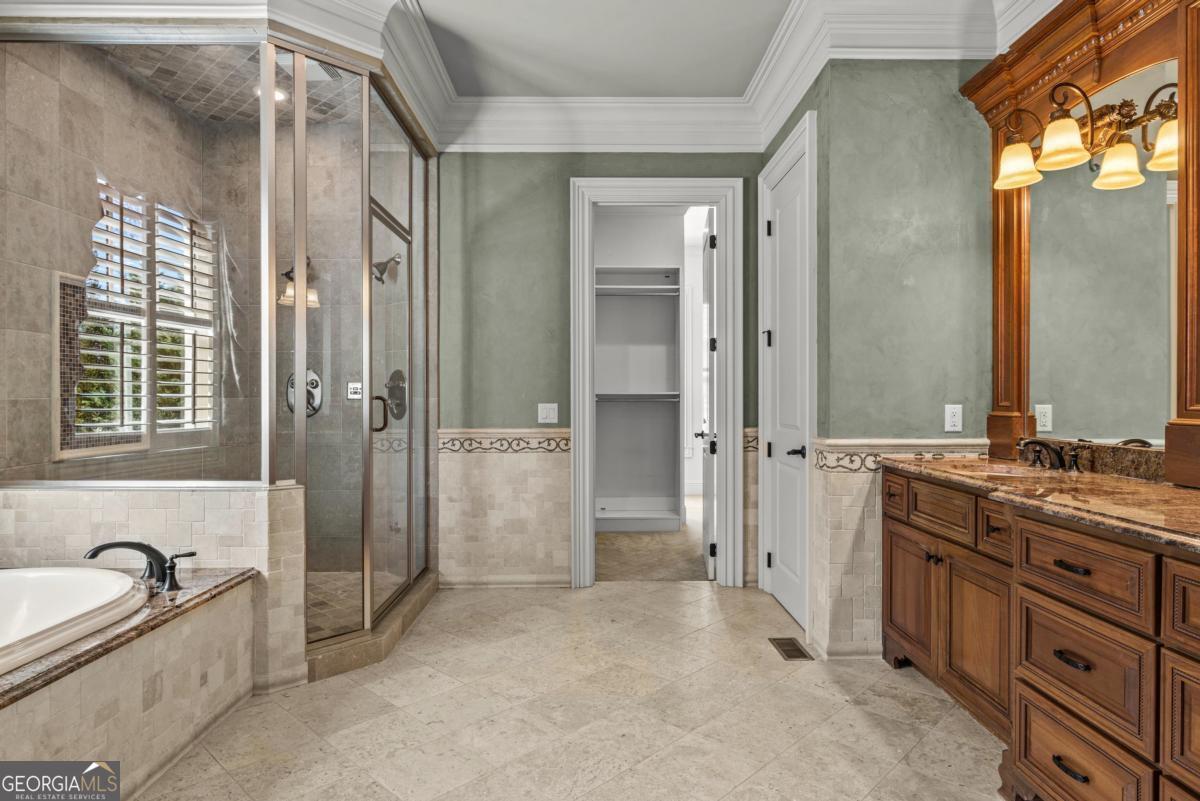 1101 Palmers View Greensboro, GA 30642 - Photo 40 of 72 a spacious bathroom with a granite countertop tub sink a mirror a shower and vanity