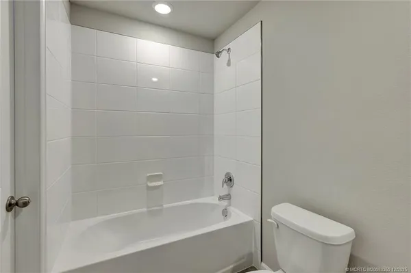 a bathroom with a bathtub and toilet