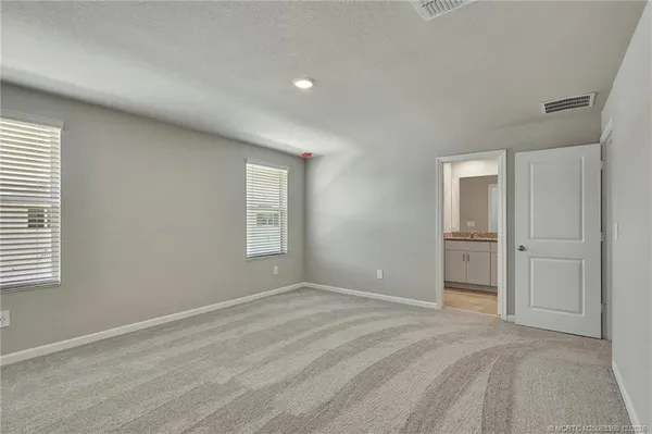 a view of empty room with closet and window