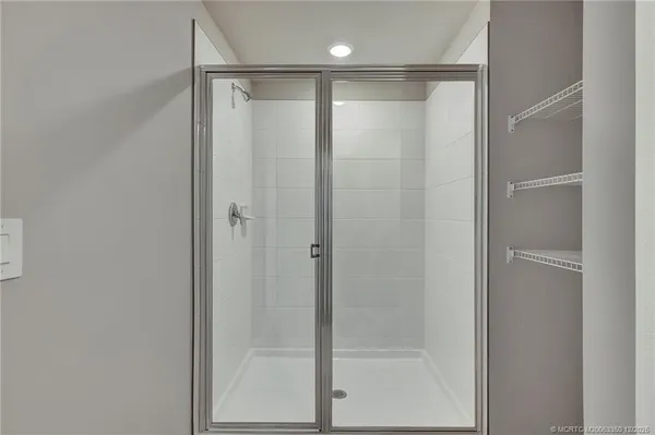 a bathroom with a glass shower door