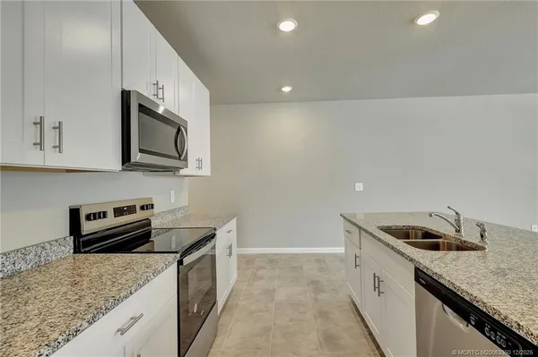 a kitchen that has a sink and a stove
