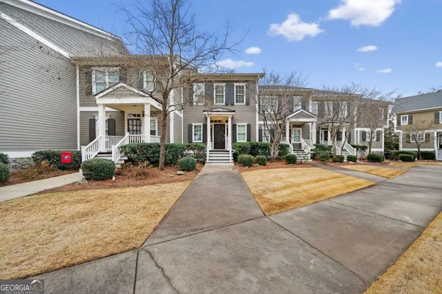 a front view of a residential houses with yard