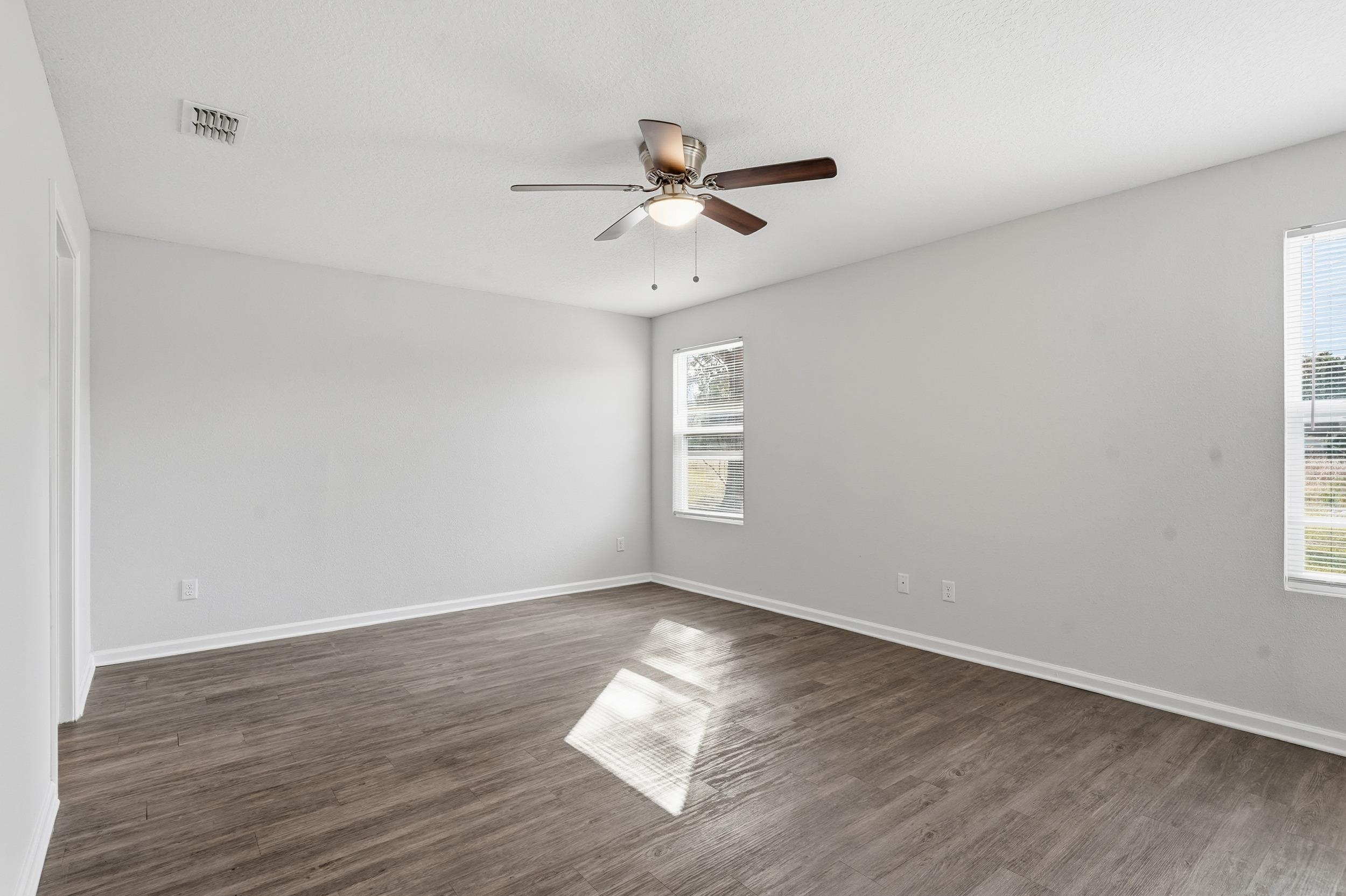 8772 Kaye Lane Jacksonville, FL 32244 - Photo 13 of 35 Empty room featuring dark wood-type flooring and ceiling fan