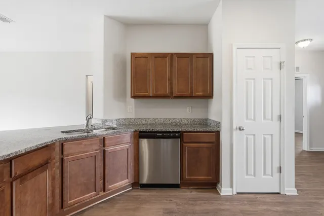 a kitchen with stainless steel appliances granite countertop a stove and a granite counter tops