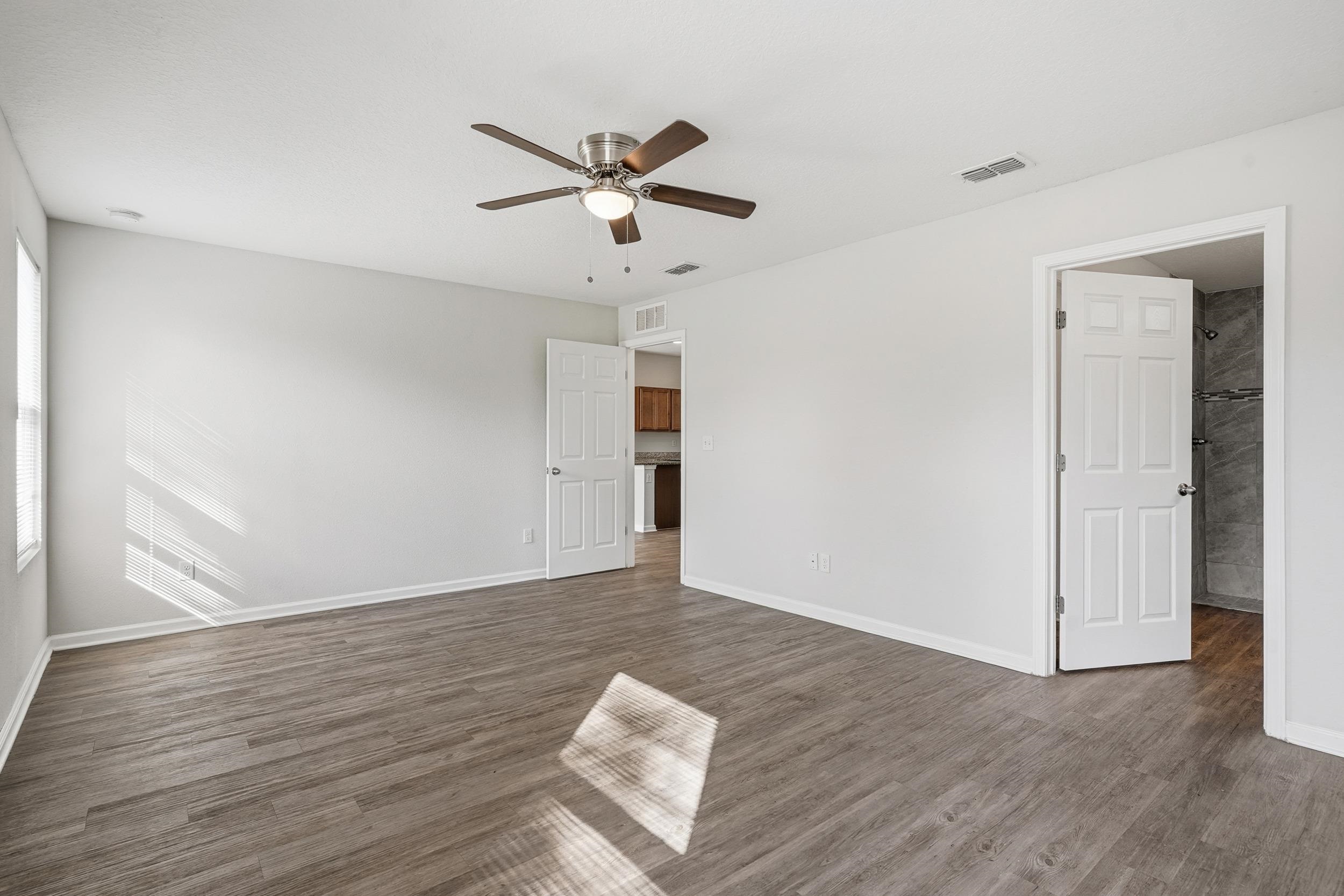 8772 Kaye Lane Jacksonville, FL 32244 - Photo 15 of 35 Unfurnished room with dark wood finished floors and a ceiling fan