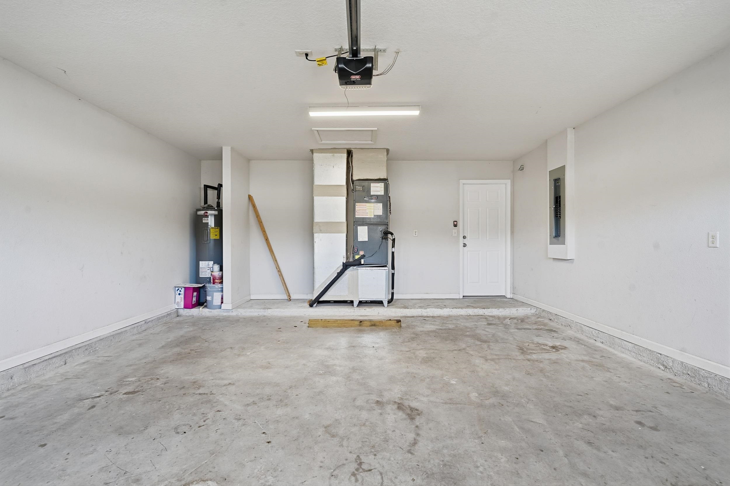 8772 Kaye Lane Jacksonville, FL 32244 - Photo 20 of 35 Garage with electric panel, water heater, and a garage door opener