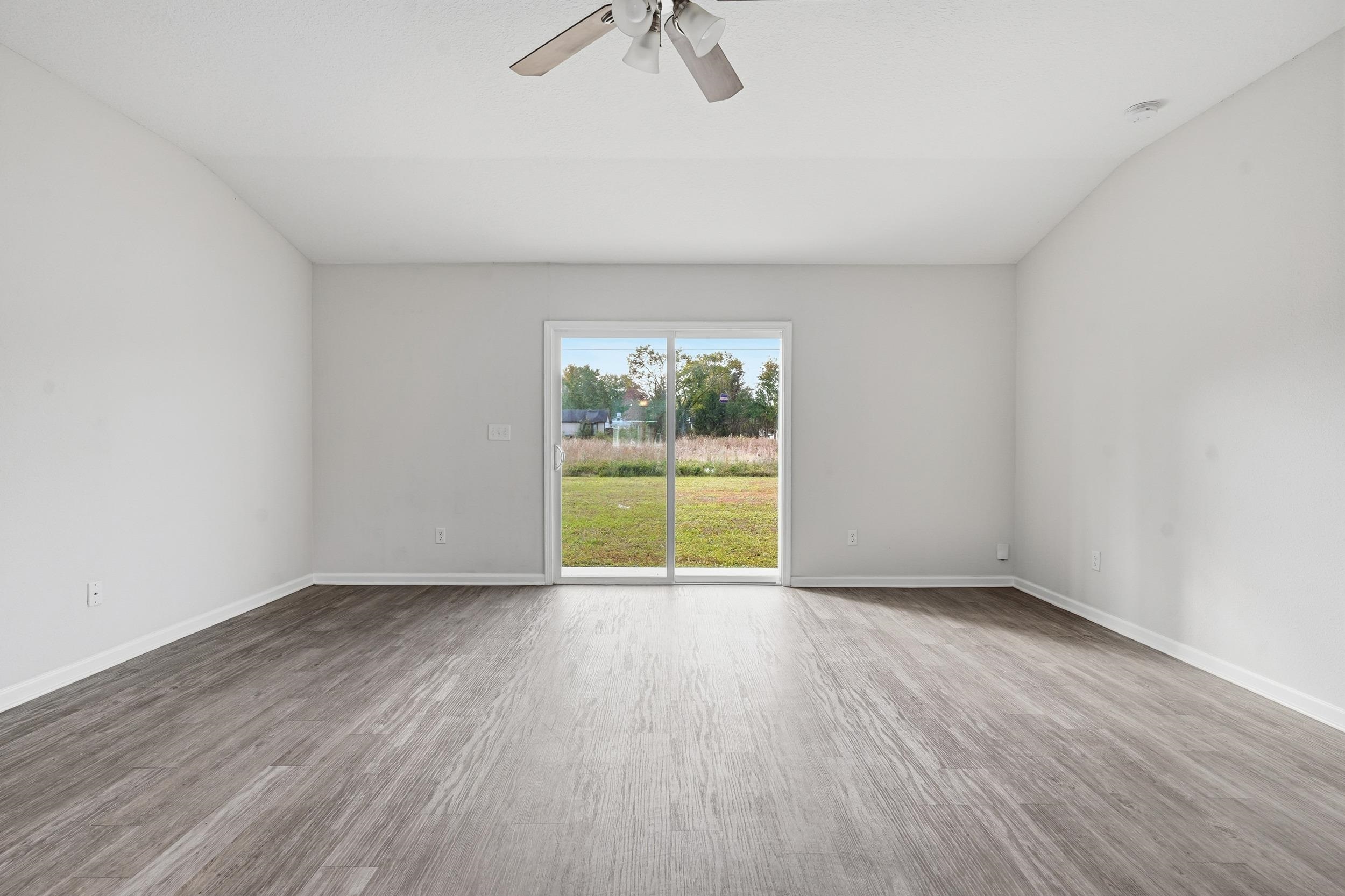 8772 Kaye Lane Jacksonville, FL 32244 - Photo 2 of 35 Empty room featuring light wood finished floors and ceiling fan