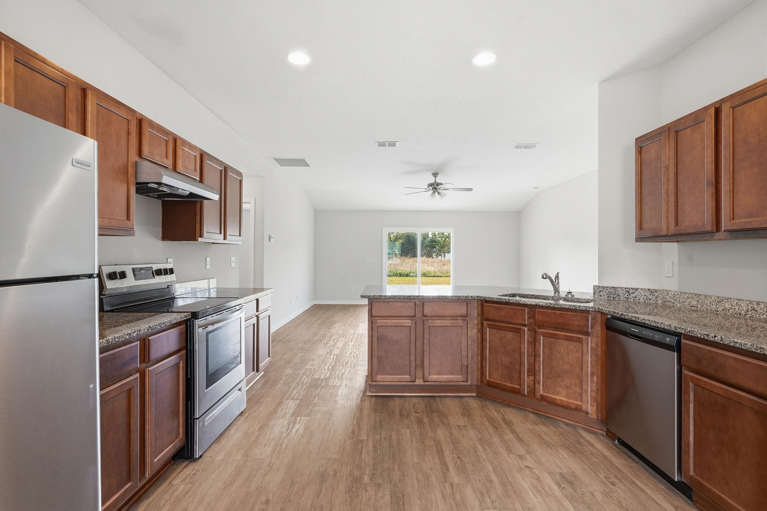 8772 Kaye Lane Jacksonville, FL 32244 - Photo 28 of 35 Kitchen with stainless steel appliances, brown cabinets, light wood-style flooring, and recessed lighting