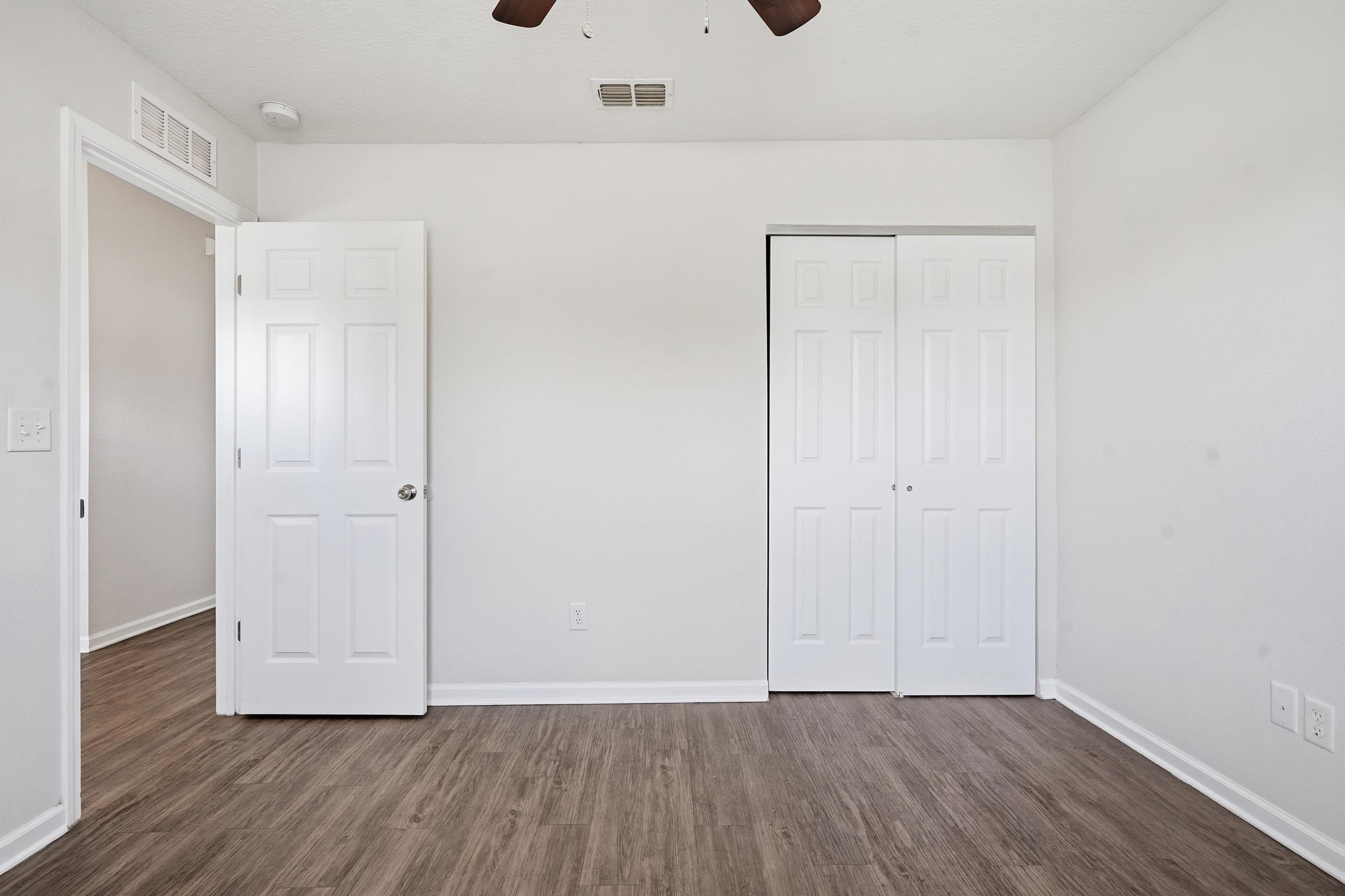 8772 Kaye Lane Jacksonville, FL 32244 - Photo 6 of 35 Unfurnished bedroom featuring dark wood finished floors, a ceiling fan, and a closet