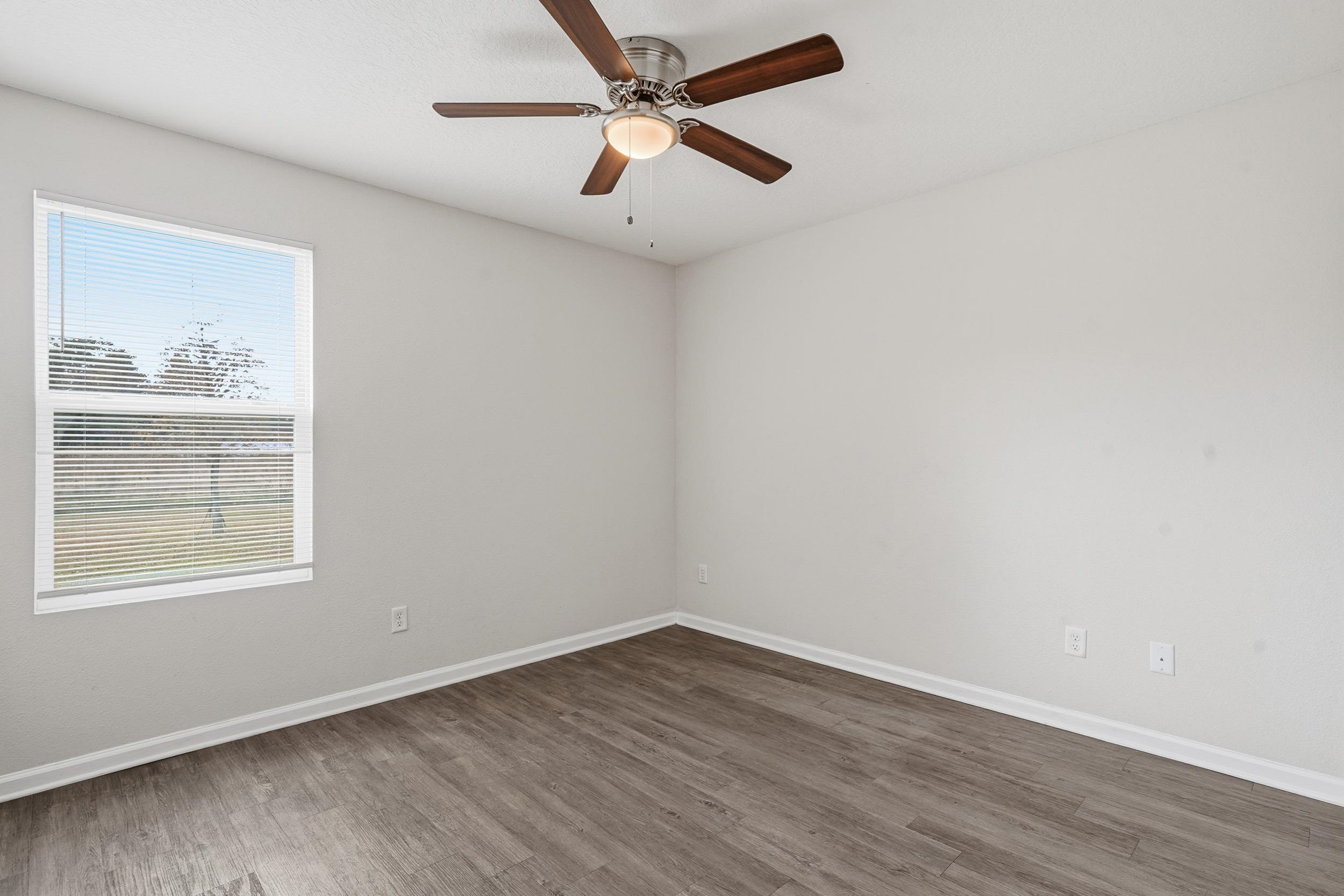 8772 Kaye Lane Jacksonville, FL 32244 - Photo 9 of 35 Empty room featuring wood finished floors and ceiling fan