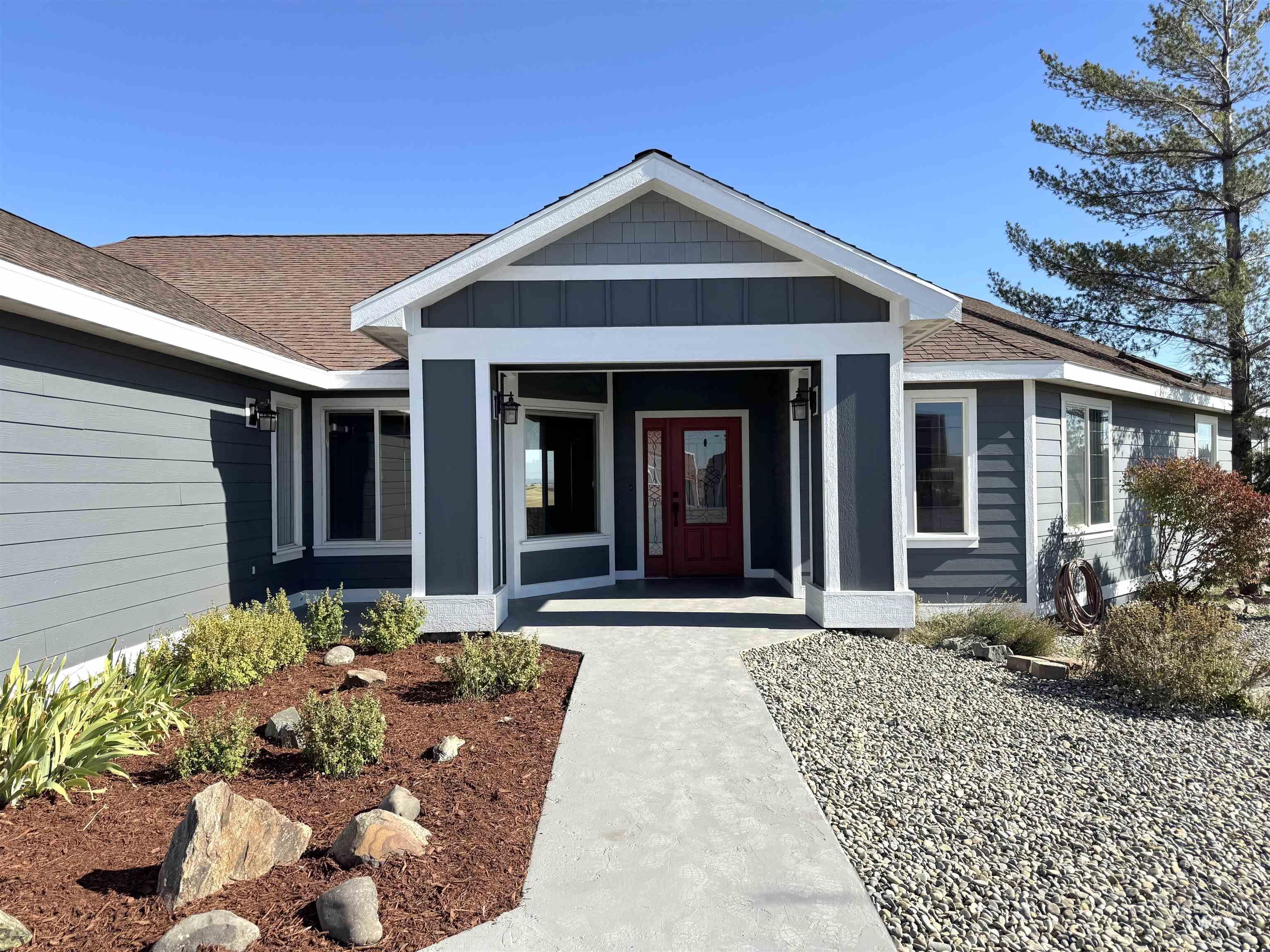 Property entrance featuring a porch, board and batten siding, and a shingled roof