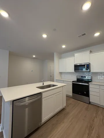 a kitchen that has a sink and a stove top oven