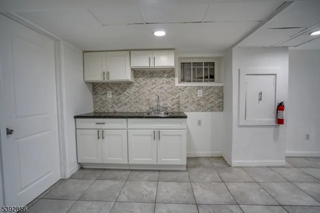a kitchen with stainless steel appliances granite countertop a sink and cabinets