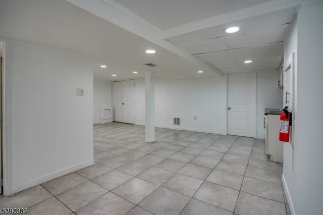 a very nice looking room with white cabinets